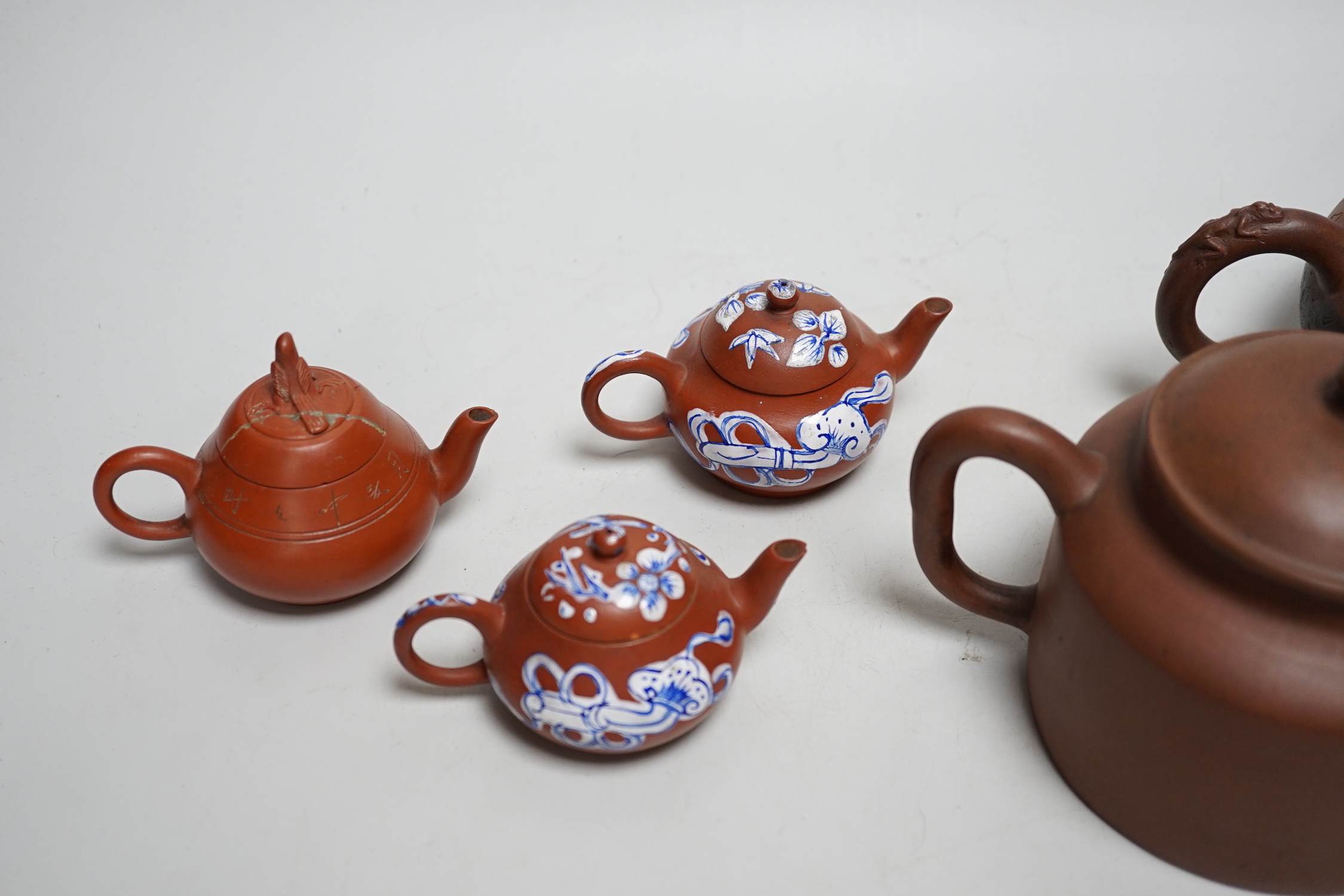 Five early 20th century Chinese Yixing teapots, widest 20cm